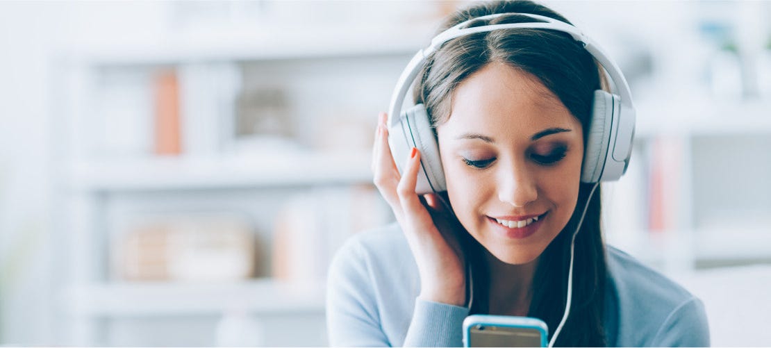 woman using phone with headphones