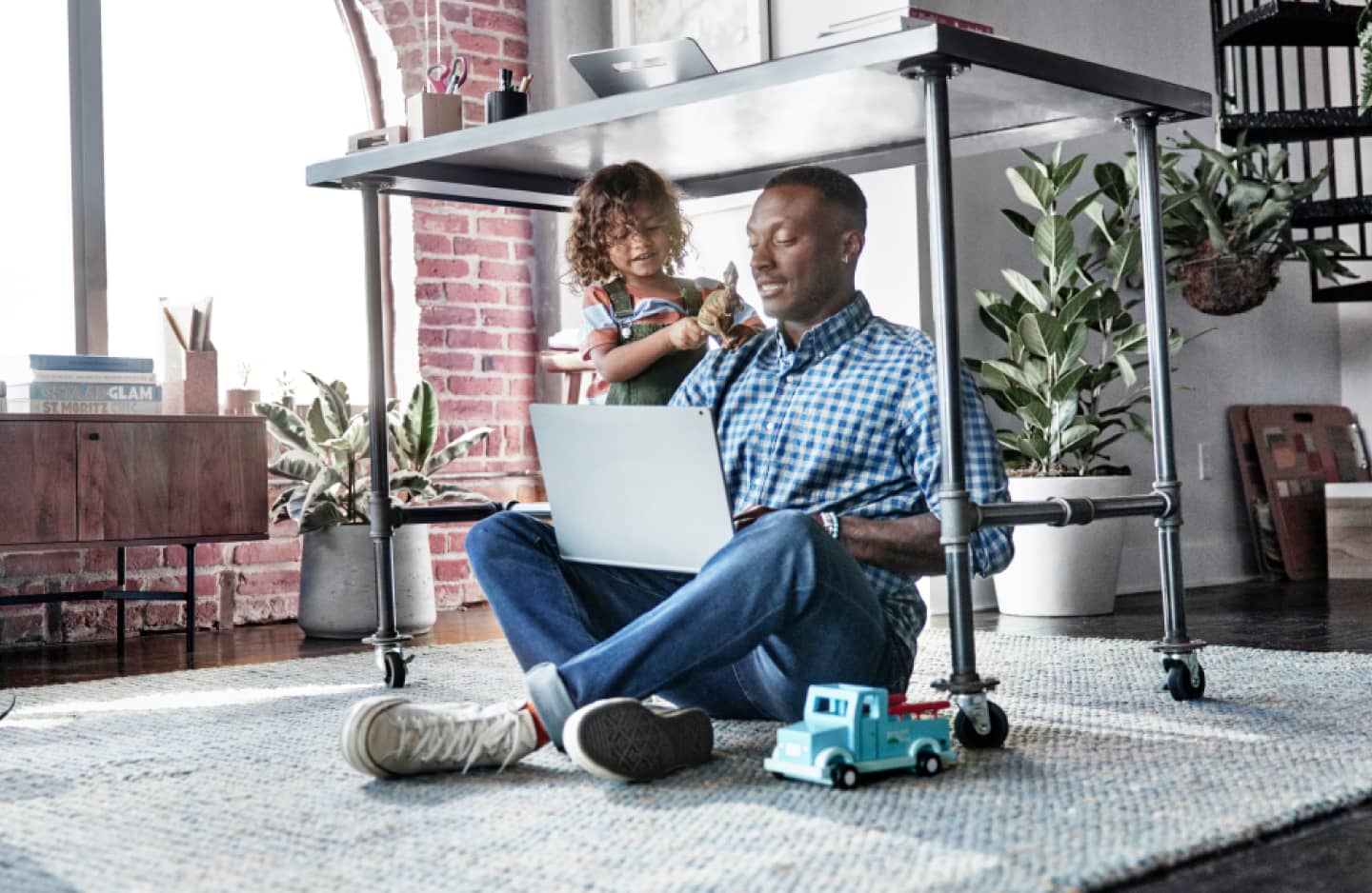 Man and child using laptop